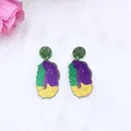 Sparkly carnival drop earrings with green purple and yellow glitter on plush background - Color Irregular