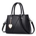Elegant black leather tote with a gold heart charm and chic triangle patchwork design - Black