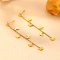 Elegant gold stainless steel butterfly tassel earrings displayed on a textured beige surface - Tassel Butterfly Stud Earrings (H303)