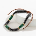 Detail of beaded bracelet with hematite, malachite texture, and adjustable cord - Gun Black