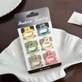 Set of 6 matte colorful mini hair claws in a decorative white shell-shaped dish - Set 8