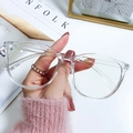 Modern oversized transparent blue light blocking glasses shown in a lifestyle hand-held shot - Frame Only (No Lens) / Transparent Frame