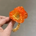 Orange poppy flower satin hair tie accessory shown in detailed hand-held view - 308 Flower Scrunchie - Orange