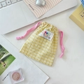 Detail of yellow checkered drawstring pouch with a pink cord and a stylish letter patch - Yellow Plaid