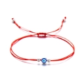 Detailed view of handmade red braided evil eye bracelet with blue bead and silver accents - Evil Eye / Red