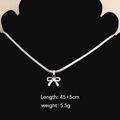 Silver bow pendant necklace on black bust, length 45+5cm, stainless steel jewelry - Bow 1 Necklace (Steel Color)