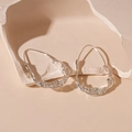 Macro shot of silver liquid metal irregular earrings with flowing lava texture detail - Silver Ellipse Ear Hook