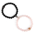 Detail of magnetic couple bracelets with matte onyx beads and golden crown charms - Rose Quartz and Matte Stone