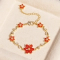 Luxuriöses 18K vergoldetes Blumenarmband mit roten Kristallen und weißen Zirkonia - Blume Roter Zirkon Gold