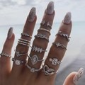 Silver-tone 14-piece ring set with crystals featuring heart and leaf designs worn on hand - Fashion Rhinestone Silver 14-Piece Set (5797)