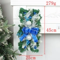 Detailed view of 45cm Christmas wreath with blue bows and ornaments on a fireplace - Blue/Luminous Swag