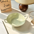 Light green ceramic salad bowl with dual handles and a glossy finish on a sunny tabletop - Light Green