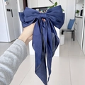 Elegant dark blue silk bow hair clip with long ribbons held in hand for women - Navy Blue