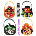 Set of 4 colorful Halloween non-woven candy gift bags featuring pumpkin and ghost designs - Halloween Candy Bag