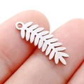 Silver stainless steel leaf pendant for DIY jewelry held by fingers for scale - DY749 Fern Leaf / Steel