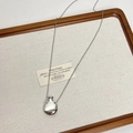 Detailed macro view of a silver perfume bottle pendant on a burlap display tray - Small Flask / Silver