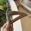 Detail of a 10cm amber brown translucent triangular hair claw clip with resin texture - Transparent Brown