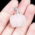 Translucent white quartz pumpkin pendant with silver clasp held in hand for jewelry size - White Crystal