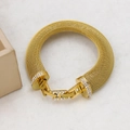 Close-up of golden mesh bracelet with zircon-studded H buckle on marble surface - YS855 Gold Bracelet