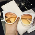 Close-up of white cat-eye sunglasses with orange gradient lenses and leather pouch - Large Cat-Eye Frame / White Frame Yellow Lens