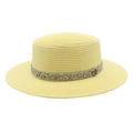 Detail of a straw boater hat with a glitter band and golden M-letter emblem - M (56-58cm) / Cow Pattern Yellow
