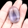 Oval purple agate gemstone cabochon for DIY jewelry setting shown on palm - Grey Agate
