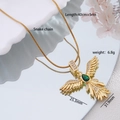 Gold-plated phoenix wing necklace with green pear gem and snake chain on mirrored display - Gold Feather Wing with Green Zirconia