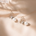 Silver butterfly pearl earrings with hollow wings and zircon on champagne silk background - Silver Butterfly