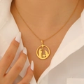 Macro detail of 18K gold-plated nativity scene pendant on a round hollow necklace - Gold