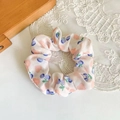 Detail of peach and blueberry print fabric scrunchie on white lace decorative pad - Beige Cherry Large