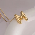 Chic 3D balloon style letter M pendant necklace in polished gold finish for women - Letter M