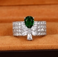 Macro detail of luxury wide band ring with pear-cut emerald zircon and micro-paved diamonds - Ur0701