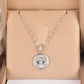 Silver evil eye necklace with blue bead and zircon accents on beige silk cushion - Silver Evil Eye