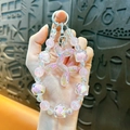 Luminous pink balloon dog beaded phone strap featuring iridescent charms and clear beads - Pink