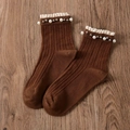Brown knit crew socks with vintage lace trim and pearl accents on wood background - One Size / Coffee