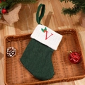 Forest green knitted Christmas stocking with white cuff and red embroidered letter V detail - Letter V