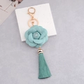 Cyan PU leather camellia flower keychain with matching tassel and gold-tone ring - Light Blue