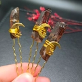 Detailed view of handmade brown crystal hair pins with gold moon and star charms - Smoky Quartz + Gold Moon Star