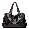 Black patent leather tote bag with brown handles and crossbody strap for women daily commute. - Black