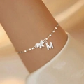 Detail of silver bow and letter M pendant bracelet worn on wrist for fashion - Letter A / Style 3 / Silver