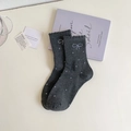 Close-up of dark grey crew socks featuring white polka dots and sweet lettuce edge cuffs - One Size / Dark Gray