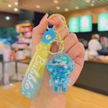 Llavero de astronauta líquido azul con correa degradada amarillo-azul y diseño de burbujas - Astronauta de Arena Movediza Azul