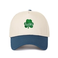 Detail of green leaf clover embroidery and white lucky script on cotton trucker cap - Adjustable / Cream/Dark Blue