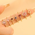 Golden rings set featuring pink heart and water drop zircons in a layered styling look - KC Gold 7-Piece Ring Set