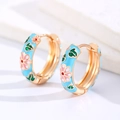 Macro detail of gold flower hoop earrings with blue enamel and pink floral pattern - Blue (Copper)
