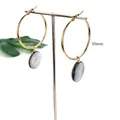Detail of 30mm gold hoop earrings with round iridescent natural black shell pendants - 30MM