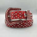 Macro shot of red leather belt featuring silver studs and red rhinestones with large buckle - Red Strap Horseshoe Buckle Red Rhinestones