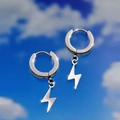 Detail view of silver stainless steel lightning bolt pendant earrings against blue sky - Short Lightning