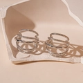 Detail of silver multi-layered C-shape earrings with a textured hammered finish on stones - Multi-layer C-shape Spiral Texture Stud Earrings / Silver
