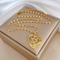 Detailed close-up of golden heart pendant featuring LOVE engraving and small crystals - Gold Heart LOVE Pendant (J536)